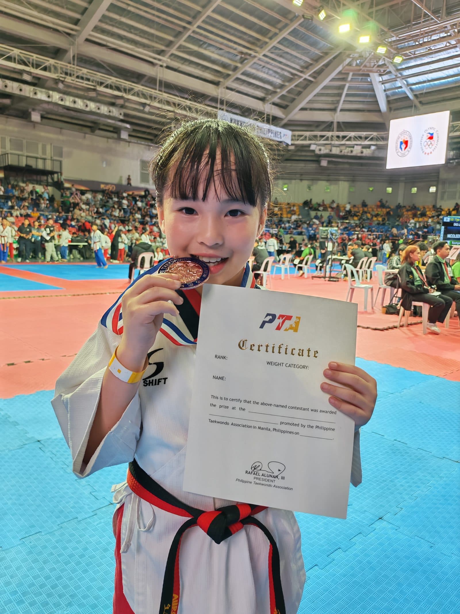 A WVT athlete smiling with her medal and certificate.