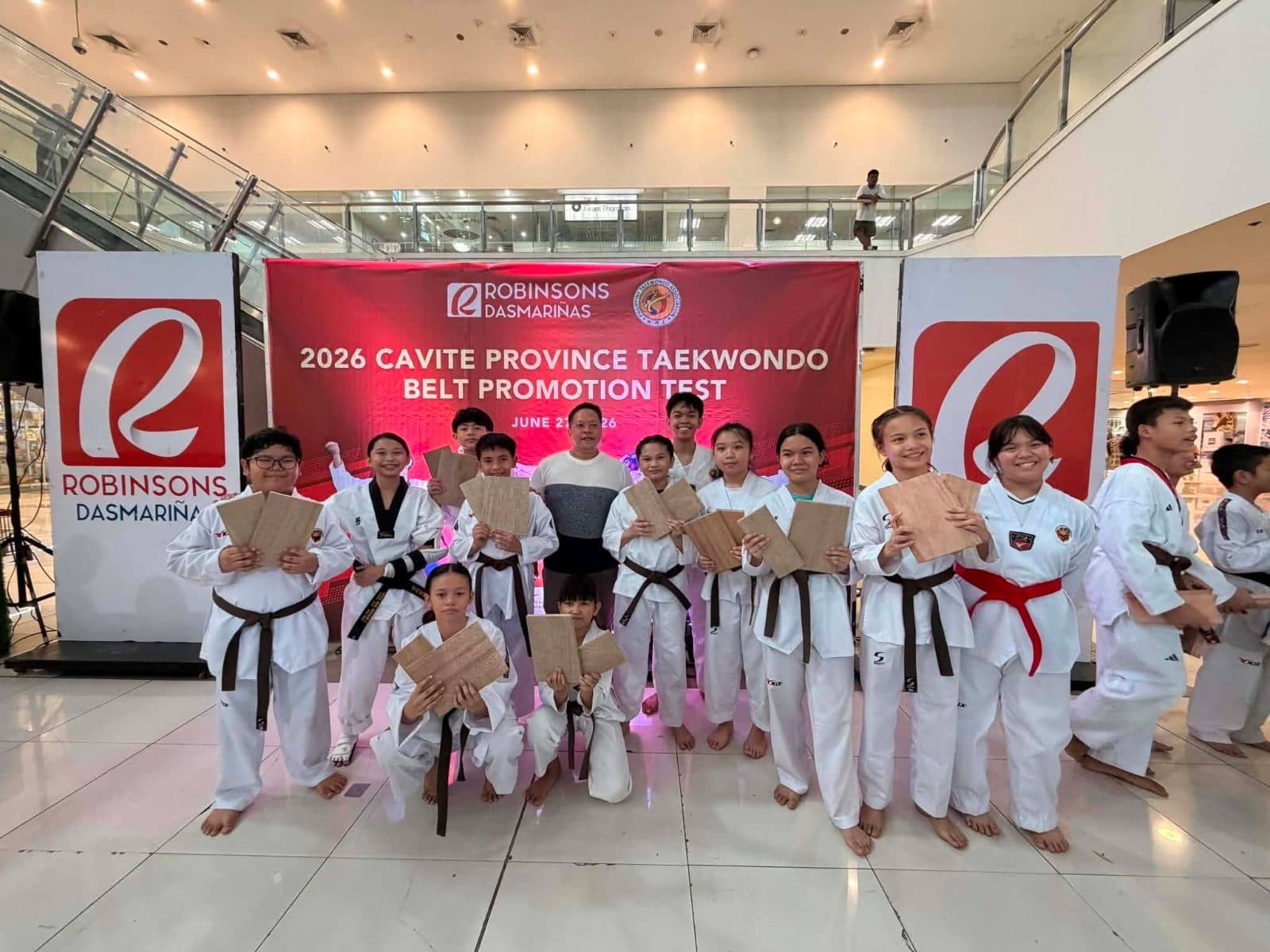 WVT students holding their certificates at the 2026 Cavite Province Taekwondo Belt Promotion Test.